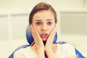 Anxious young woman seated at orthodontics appointment