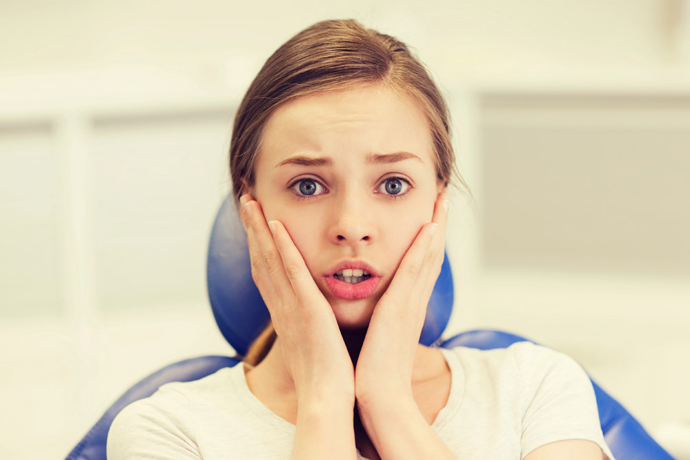 Anxious young woman seated at orthodontics appointment